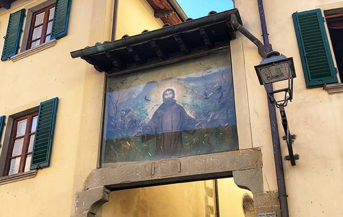 Painting of St Francis on the walkway in Stia, fresco by Pietro Annigoni